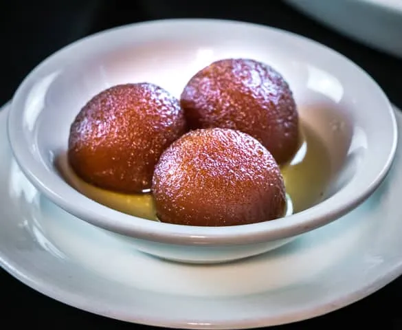 Gulab jamun, soft milk dumplings in warm syrup, an Indian dessert at Shehnai Restaurant in Hamilton