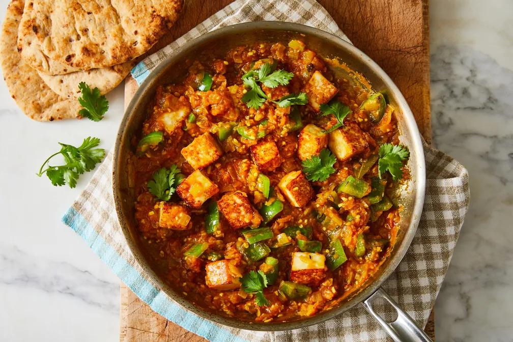 Vegetarian paneer karahi with green peppers, onions and tomatoes served with naan at Shehnai Restaurant in Hamilton